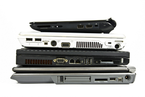 A stack of different types of laptops.